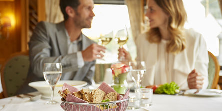 Ein Paar stößt bei ihrem Dinner mit Weißwein an 
