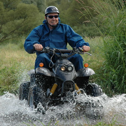 [Translate to english:] Mann fährt auf einem Quad.