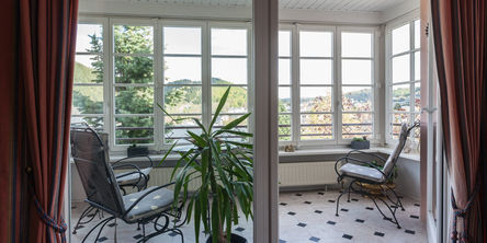 Balkon mit zwei Stühlen und einem Blick über die Landschaft 