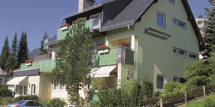 Außenansicht des Haus Sonnenuhr bei Sonnenschein 